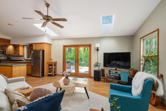 9707 Rogers Rd, Alanson, MI 49706 - living area featuring a skylight, light wood-style flooring, french doors, and a ceiling fan