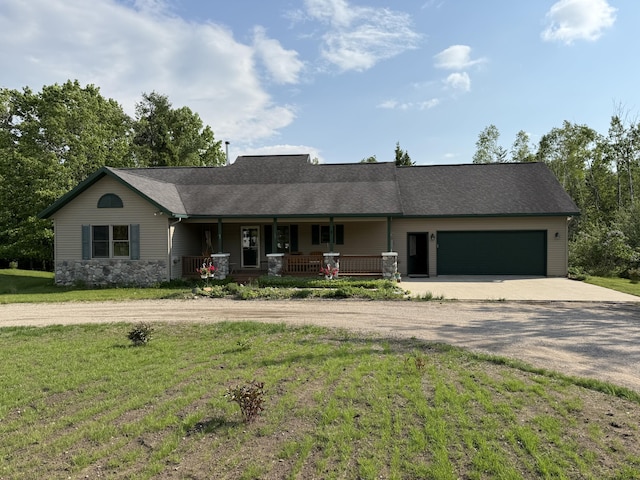 1058 Marlas Way, Cheboygan, MI 49721 - view of front of home featuring concrete driveway, a porch, a front yard, an attached garage, and roof with shingles