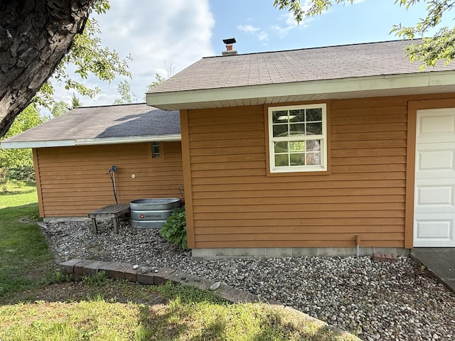 1058 Marlas Way, Cheboygan, MI 49721 - view of home's exterior with a garage and roof with shingles