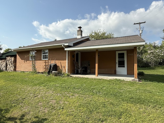 1058 Marlas Way, Cheboygan, MI 49721 - rear view of property with a lawn, a patio area, and a chimney