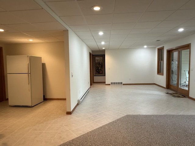 1058 Marlas Way, Cheboygan, MI 49721 - empty room featuring a baseboard radiator, light tile patterned floors, baseboards, recessed lighting, and a paneled ceiling