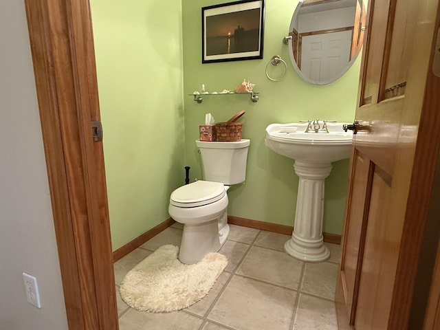 1058 Marlas Way, Cheboygan, MI 49721 - bathroom with toilet, tile patterned floors, and baseboards