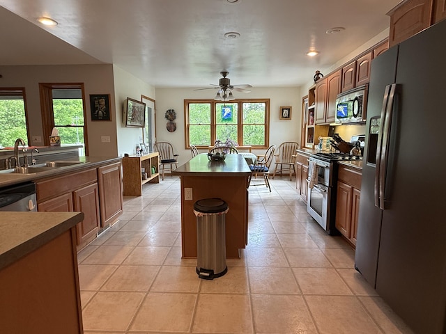 1058 Marlas Way, Cheboygan, MI 49721 - kitchen featuring stainless steel appliances, a sink, a center island, a ceiling fan, and dark countertops