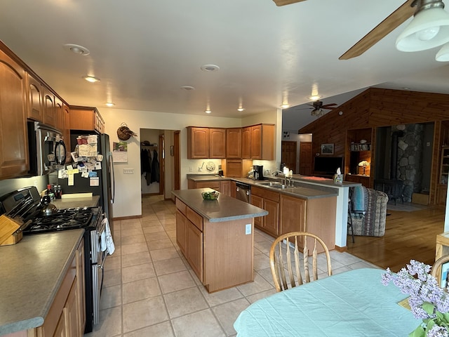 1058 Marlas Way, Cheboygan, MI 49721 - kitchen with appliances with stainless steel finishes, a sink, a ceiling fan, a peninsula, and light tile patterned floors