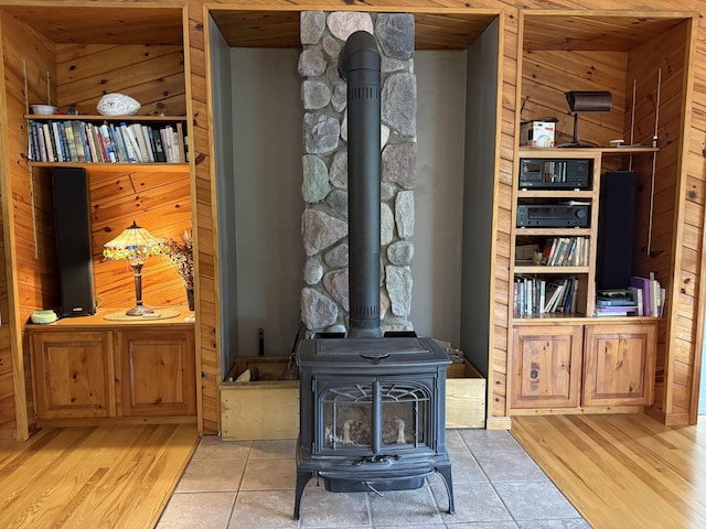 1058 Marlas Way, Cheboygan, MI 49721 - detailed view of a wood stove, wood finished floors, and wood walls
