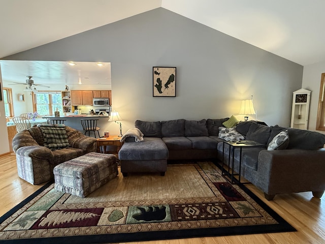 1058 Marlas Way, Cheboygan, MI 49721 - living room with light wood-style floors, ceiling fan, and high vaulted ceiling