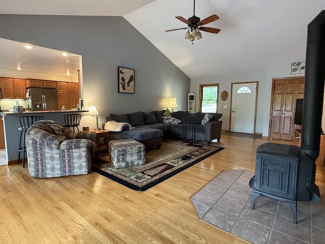 1058 Marlas Way, Cheboygan, MI 49721 - living area with a wood stove, a ceiling fan, light wood-style flooring, and high vaulted ceiling