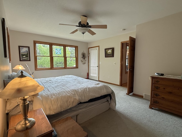 1058 Marlas Way, Cheboygan, MI 49721 - bedroom featuring light carpet, baseboards, and ceiling fan