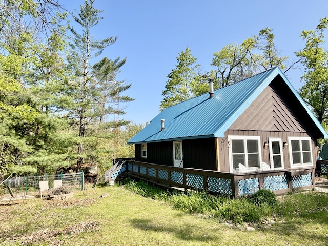 5265 Woodridge Dr, Lewiston, MI 49756 - rear view of house featuring metal roof