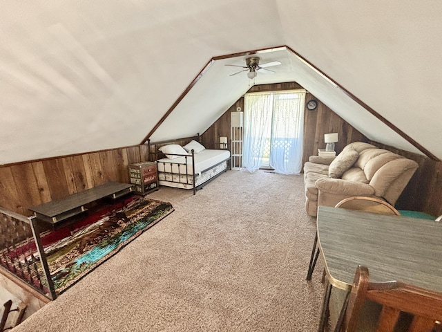 5265 Woodridge Dr, Lewiston, MI 49756 - carpeted bedroom with wooden walls, access to exterior, vaulted ceiling, and a ceiling fan