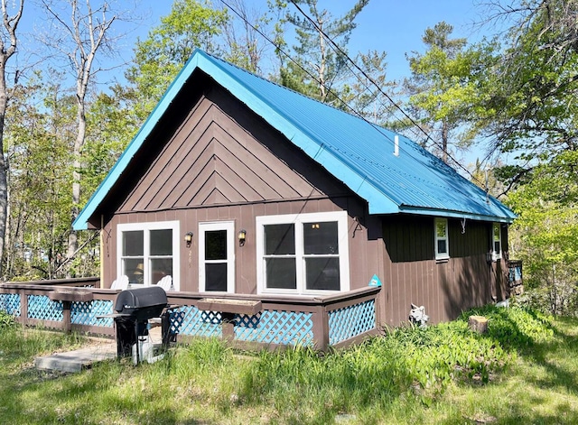 5265 Woodridge Dr, Lewiston, MI 49756 - view of front of house with metal roof