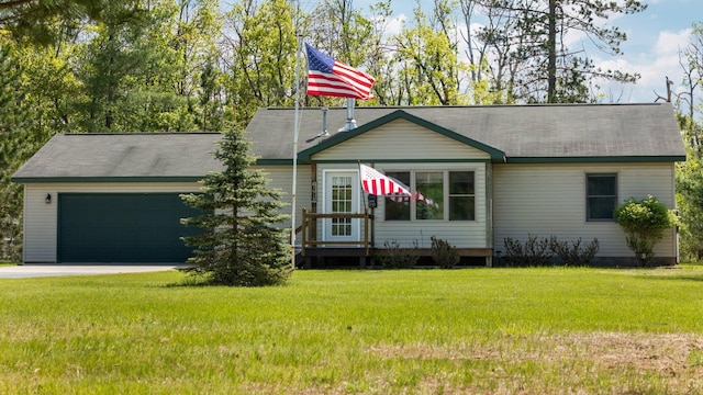 5918 Neumann Rd, Lewiston, MI 49756 - view of front of house featuring a garage, a front yard, driveway, and a shingled roof