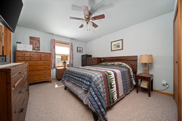 5918 Neumann Rd, Lewiston, MI 49756 - bedroom with light colored carpet, ceiling fan, and baseboards
