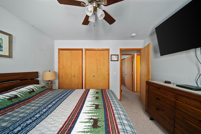 5918 Neumann Rd, Lewiston, MI 49756 - bedroom with multiple closets, light carpet, and a ceiling fan