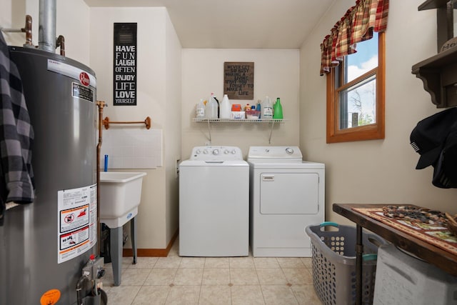 5918 Neumann Rd, Lewiston, MI 49756 - laundry room with water heater, independent washer and dryer, light tile patterned floors, and baseboards