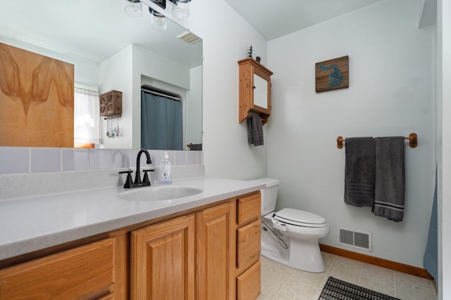 5918 Neumann Rd, Lewiston, MI 49756 - bathroom featuring vanity, toilet, baseboards, and tile patterned floors