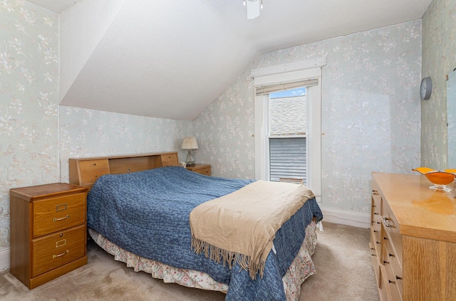 211 S Birney St, Bay City, MI 48708 - bedroom with wallpapered walls, light colored carpet, vaulted ceiling, and baseboards