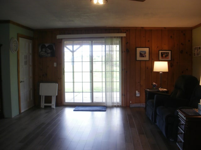 6121 M-33 Hwy, Onaway, MI 49765 - living area with dark wood-style flooring and wooden walls