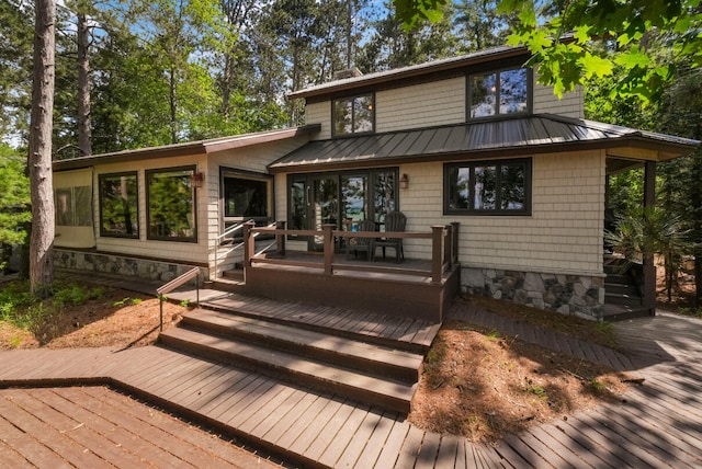 117 Timber Trl, Roscommon, MI 48653 - rear view of property with a standing seam roof, a wooden deck, and a metal roof