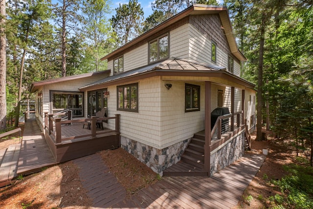 117 Timber Trl, Roscommon, MI 48653 - view of front facade featuring a standing seam roof, a metal roof, and a wooden deck