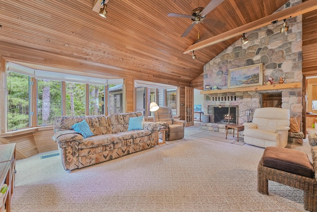 117 Timber Trl, Roscommon, MI 48653 - living area with a wood ceiling with exposed beams, a stone fireplace, ceiling fan, high vaulted ceiling, and track lighting