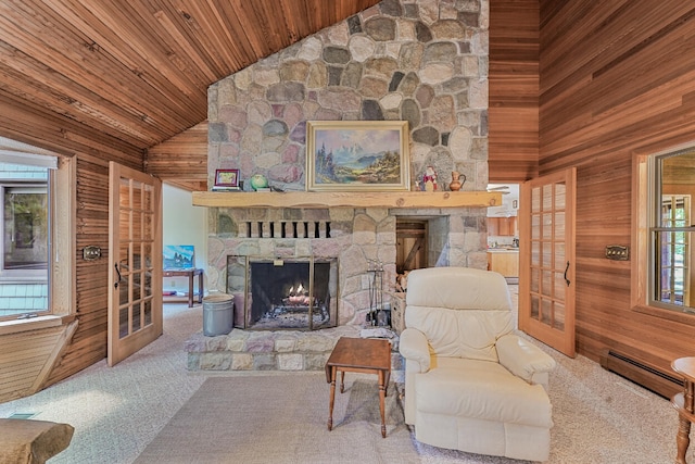 117 Timber Trl, Roscommon, MI 48653 - living room featuring a baseboard radiator, a fireplace, wooden ceiling, carpet flooring, and wooden walls
