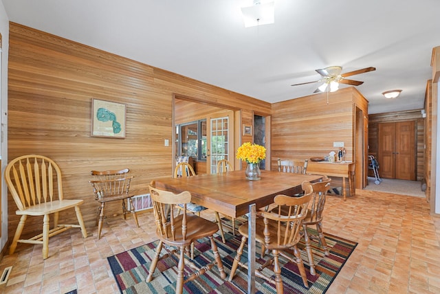 117 Timber Trl, Roscommon, MI 48653 - dining room featuring wooden walls and ceiling fan