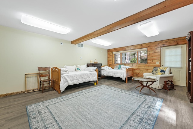 117 Timber Trl, Roscommon, MI 48653 - bedroom featuring beam ceiling, wood finished floors, and wood walls