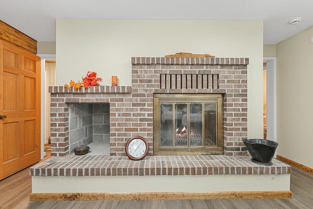 117 Timber Trl, Roscommon, MI 48653 - detailed view of a fireplace, wood finished floors, and a smoke detector