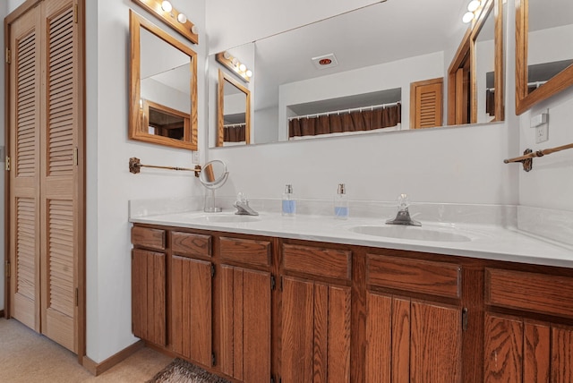 117 Timber Trl, Roscommon, MI 48653 - bathroom featuring a closet and double vanity