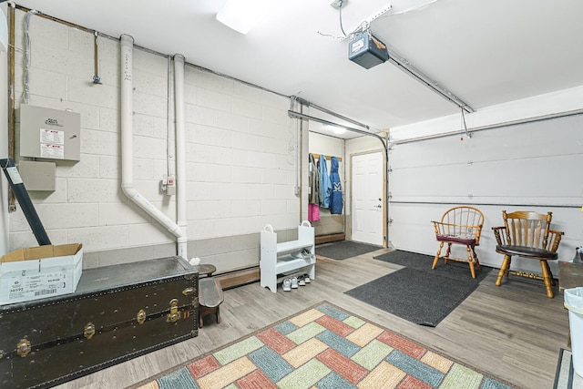 117 Timber Trl, Roscommon, MI 48653 - garage featuring a garage door opener and concrete block wall