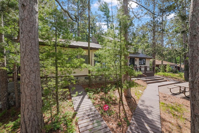 117 Timber Trl, Roscommon, MI 48653 - rear view of house featuring a standing seam roof, a deck, and a metal roof