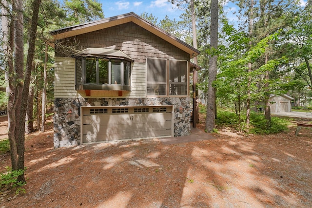 117 Timber Trl, Roscommon, MI 48653 - view of patio with dirt driveway and an attached garage