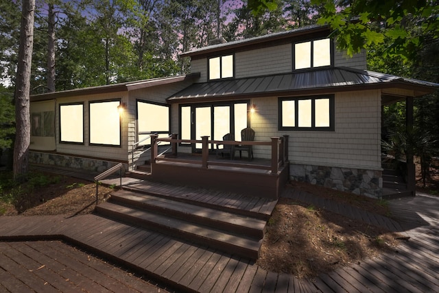 117 Timber Trl, Roscommon, MI 48653 - back of property featuring a wooden deck, a standing seam roof, and a metal roof
