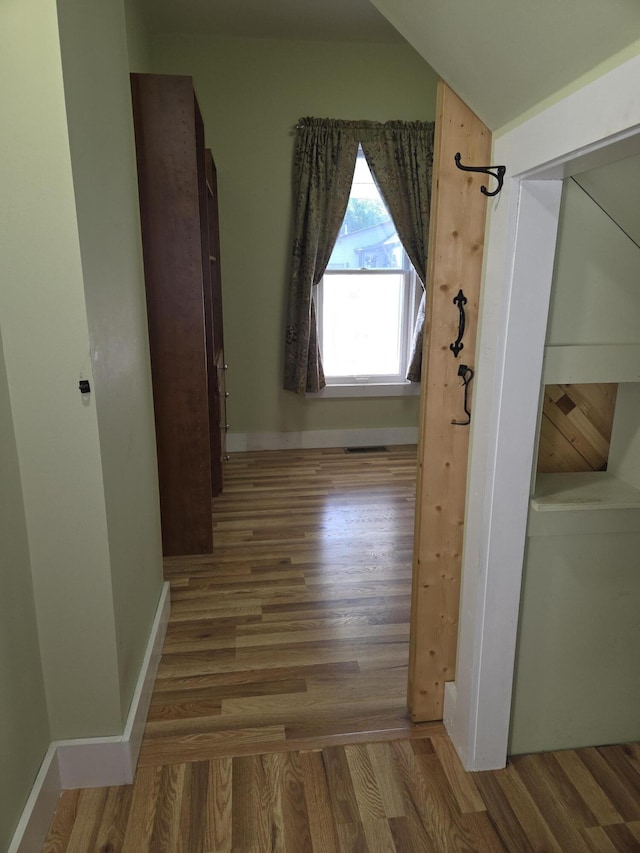 208 S S D St, Cheboygan, MI 49721 - corridor featuring wood finished floors and baseboards