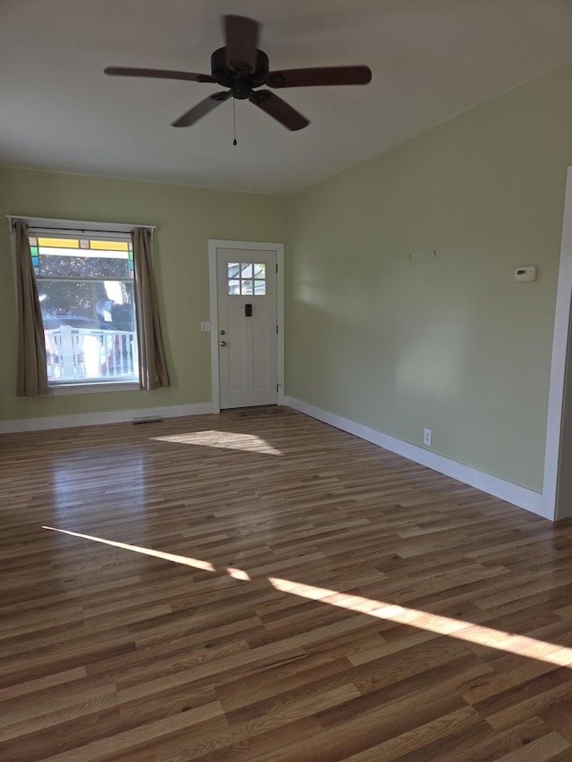 208 S S D St, Cheboygan, MI 49721 - entrance foyer featuring wood finished floors, a ceiling fan, and baseboards