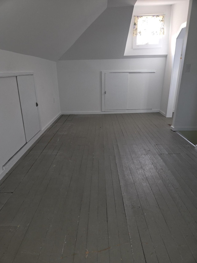 208 S S D St, Cheboygan, MI 49721 - additional living space with wood-type flooring, lofted ceiling, and baseboards