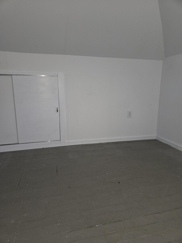 208 S S D St, Cheboygan, MI 49721 - additional living space featuring baseboards and vaulted ceiling