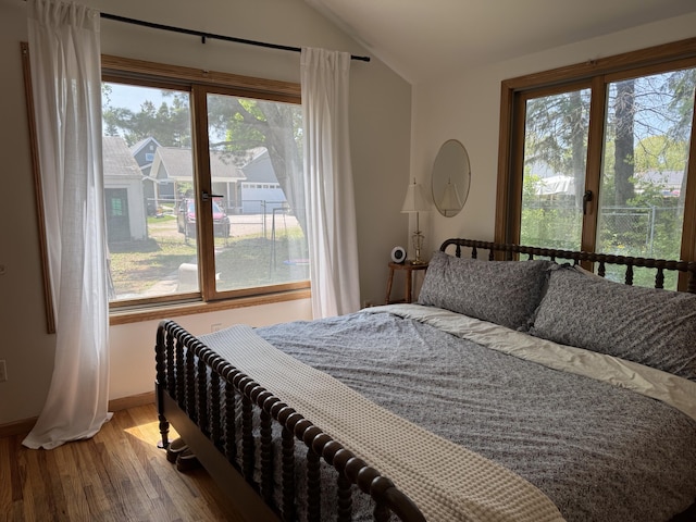 2111 W 3rd, Sault Ste Marie, MI 49783 - bedroom with lofted ceiling, wood finished floors, and baseboards