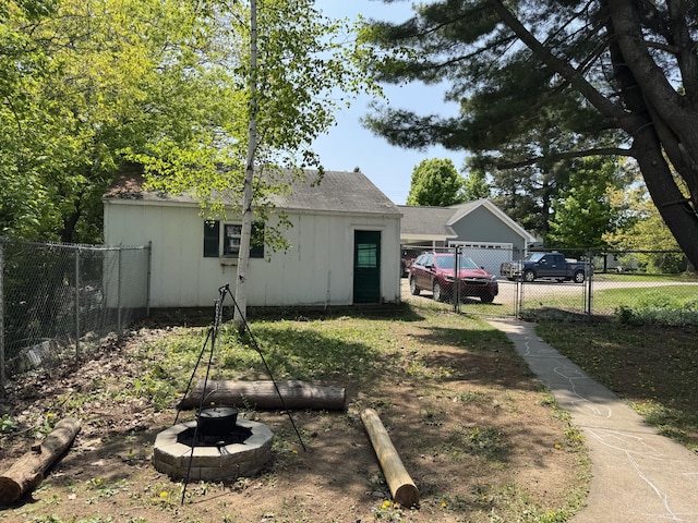 2111 W 3rd, Sault Ste Marie, MI 49783 - rear view of house with a fire pit and board and batten siding
