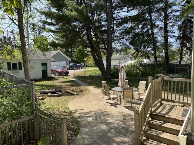 2111 W 3rd, Sault Ste Marie, MI 49783 - view of patio / terrace featuring outdoor dining space, a garage, and a deck