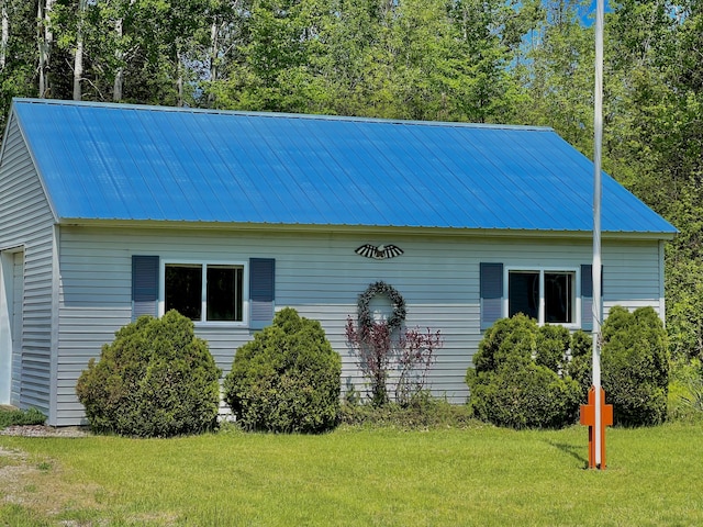 1745 Mullett Lake Woods Rd, Cheboygan, MI 49721 - view of property exterior featuring metal roof and a lawn
