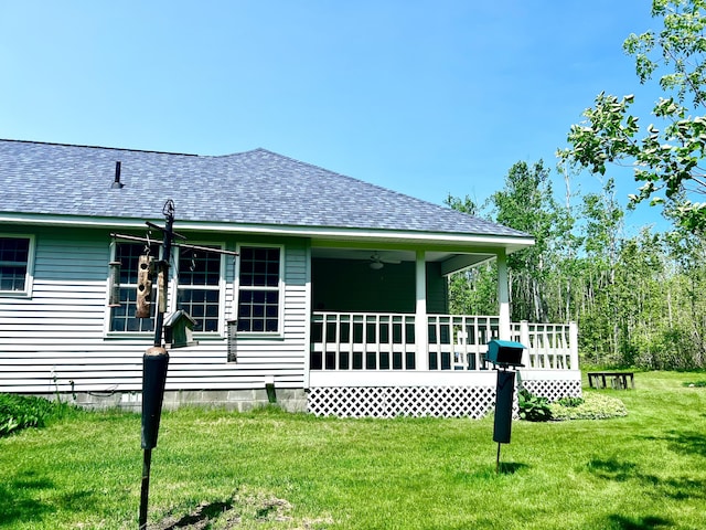 1745 Mullett Lake Woods Rd, Cheboygan, MI 49721 - rear view of house featuring roof with shingles, a yard, ceiling fan, and a wooden deck