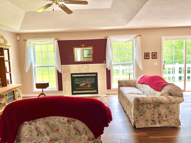 1745 Mullett Lake Woods Rd, Cheboygan, MI 49721 - living area with hardwood / wood-style floors, plenty of natural light, a ceiling fan, and a textured ceiling