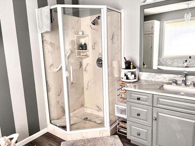 1745 Mullett Lake Woods Rd, Cheboygan, MI 49721 - full bathroom featuring a marble finish shower, vanity, and wood finished floors