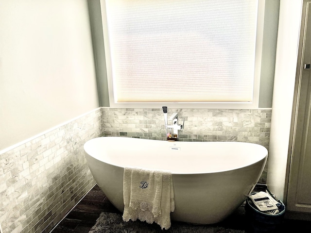 1745 Mullett Lake Woods Rd, Cheboygan, MI 49721 - full bathroom featuring tile walls, a wainscoted wall, and a soaking tub