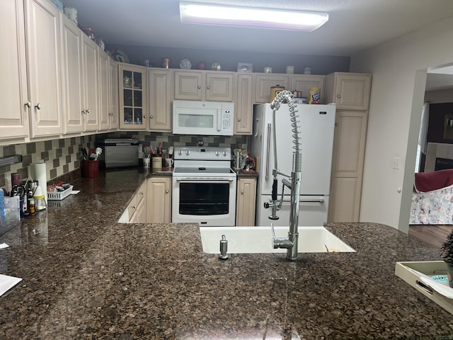 1745 Mullett Lake Woods Rd, Cheboygan, MI 49721 - kitchen featuring white appliances, glass insert cabinets, decorative backsplash, and dark stone countertops