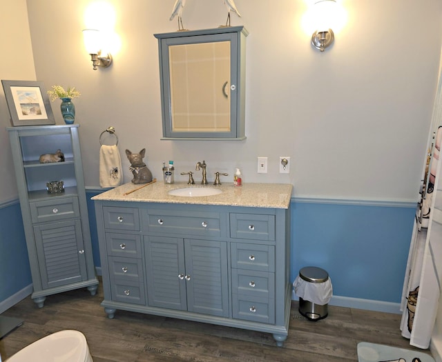 106 Hazel St, Saint Ignace, MI 49781 - full bathroom featuring wood finished floors, vanity, and baseboards