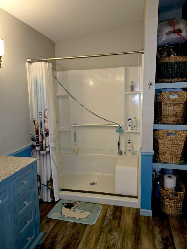 106 Hazel St, Saint Ignace, MI 49781 - bathroom with a shower with shower curtain, wood finished floors, and vanity