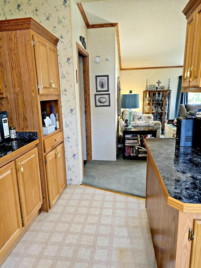 106 Hazel St, Saint Ignace, MI 49781 - kitchen featuring wallpapered walls, crown molding, open floor plan, a textured ceiling, and light floors